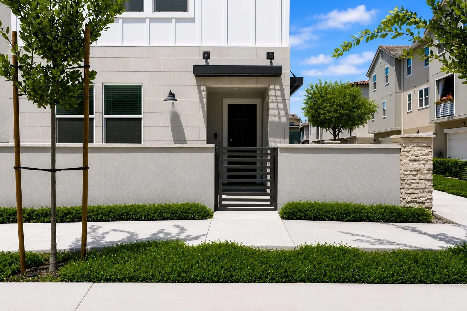 Modern townhome entry with a gated front courtyard