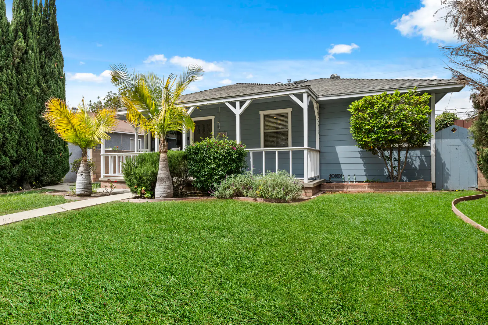 Craftsman-style home behind a green front lawn